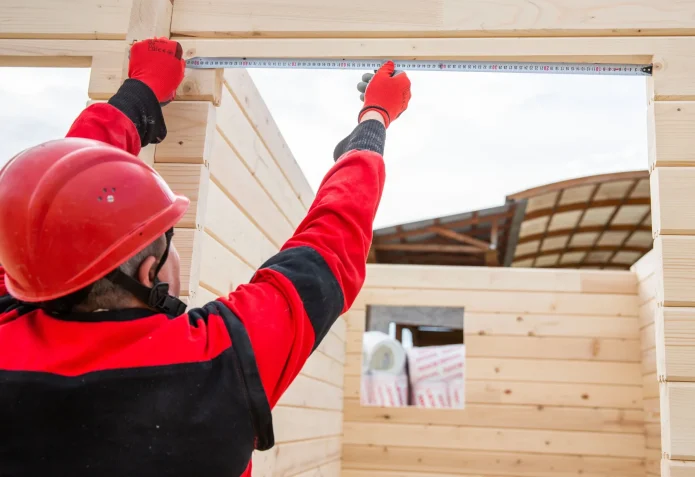 construction worker measures the